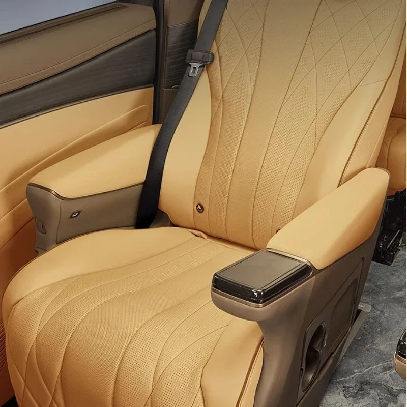 Tan perforated leather car seat with diamond stitching and integrated armrests.