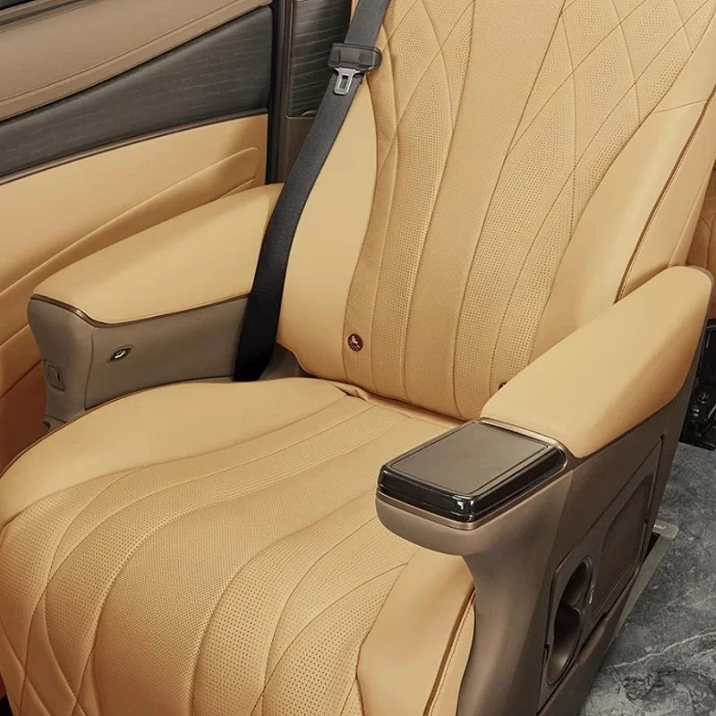 Tan perforated leather car seat with diamond stitching and integrated armrests.