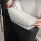 Close-up of a premium light gray leather armrest cover for a car interior.