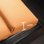 Close-up of tan perforated leather car mat showing a 30mm edge thickness.