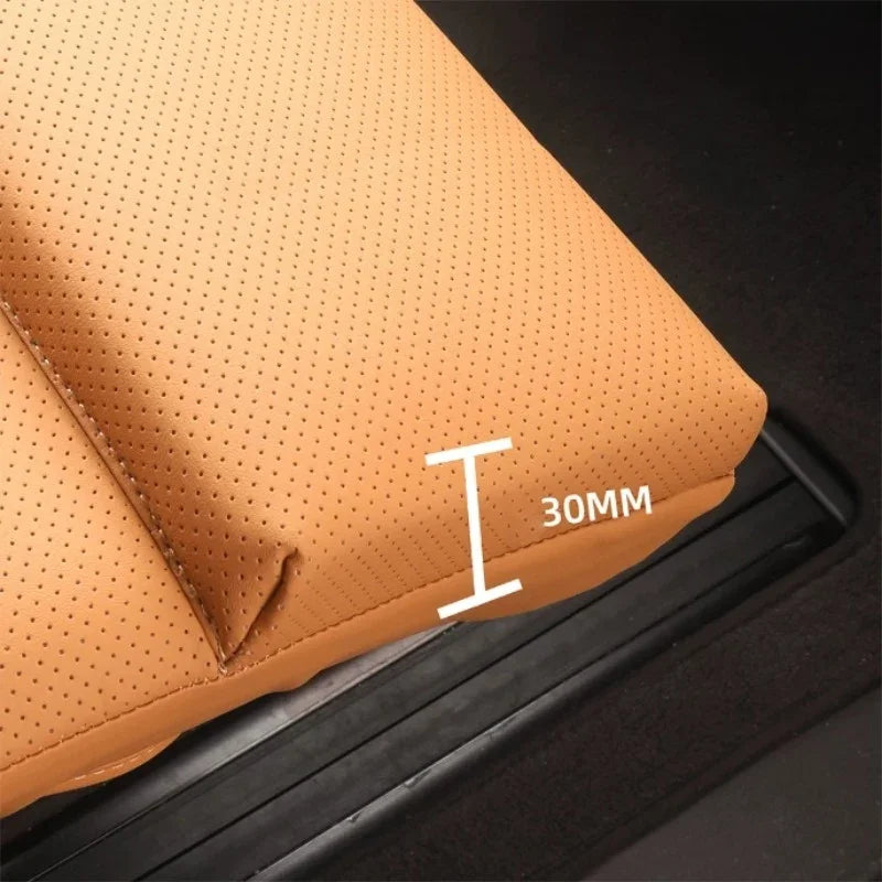 Close-up of tan perforated leather car mat showing a 30mm edge thickness.