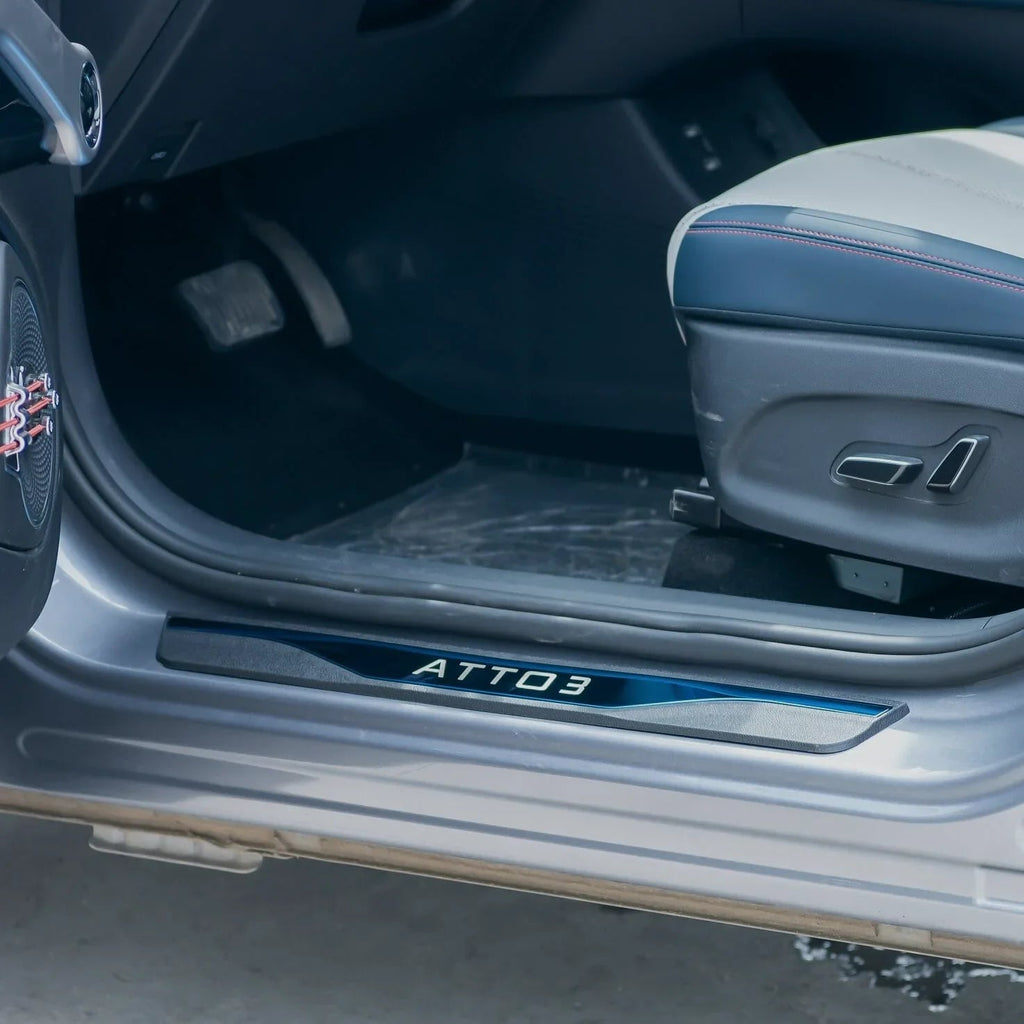Black ATTO 3 branded door sill protector with sleek metallic finish for car interior protection.