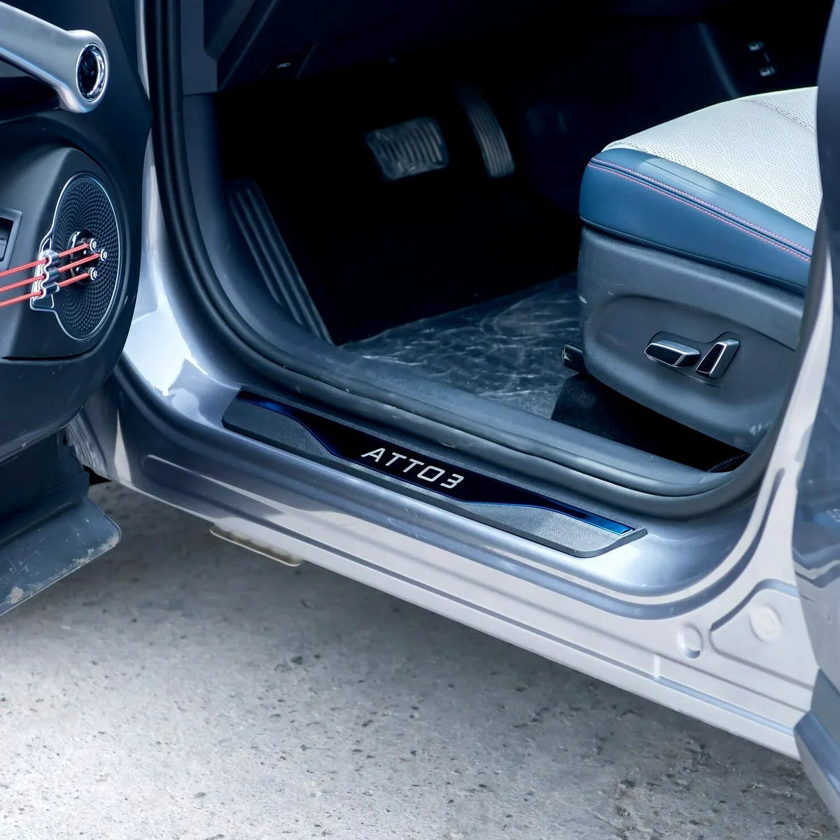 Black ATTO 3 protective door sill plate with sleek metallic finish for BYD interior protection.