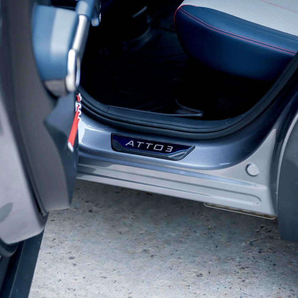 Sleek black ATTO 3 protective door sill plate installed on a grey BYD vehicle.