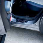 Sleek black ATTO 3 protective door sill plate installed on a grey BYD vehicle.
