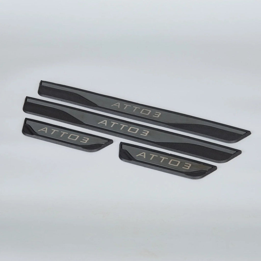 Black matte metallic door sill protectors with silver ATTO 3 engraving for car protection.