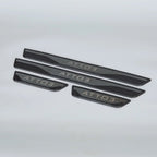 Black matte metallic door sill protectors with silver ATTO 3 engraving for car protection.