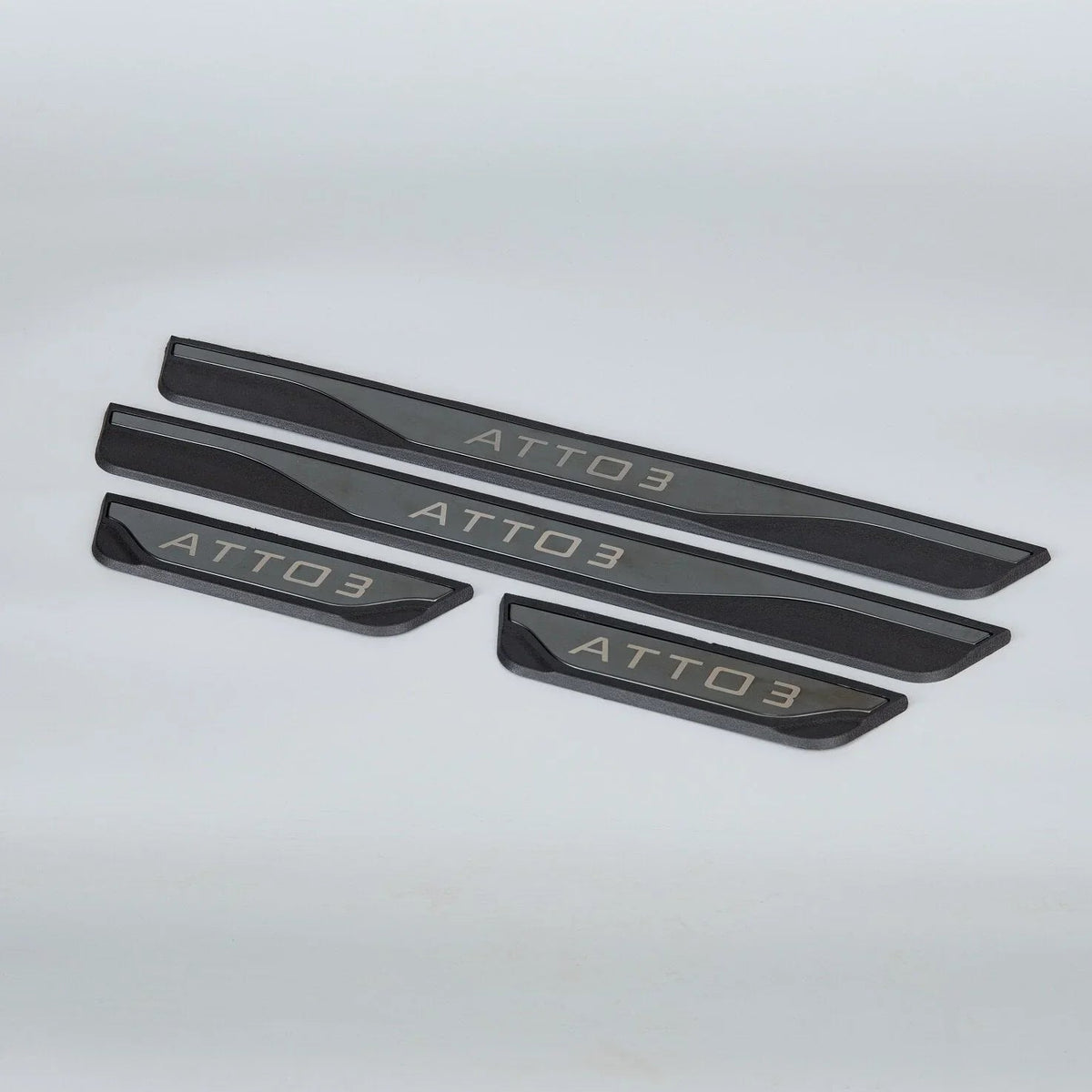 Black matte metallic door sill protectors with silver ATTO 3 engraving for car protection.