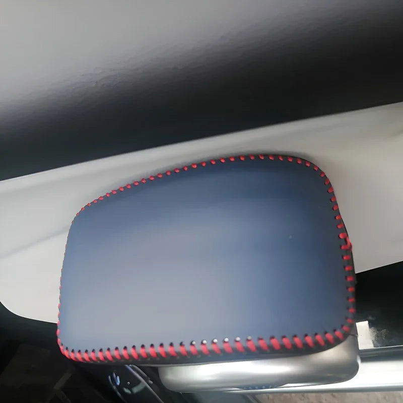 Premium navy blue leather sun visor cover with contrasting red stitching for car interior protection.