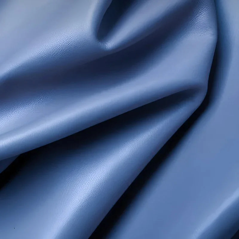 Smooth blue synthetic leather material with a subtle grain texture