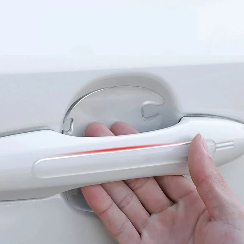 Transparent TPU car door handle protector film applied to a white vehicle door.