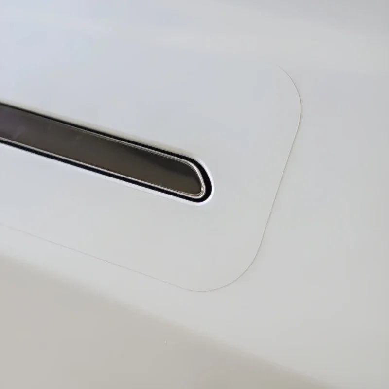 White protective car door handle film with a chrome handle accent.