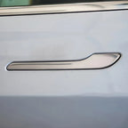 Silver chrome door handle protector installed on a white car door
