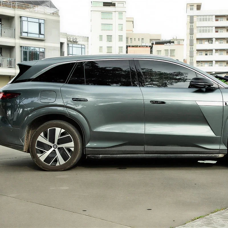 Side view of a sleek grey metallic electric SUV featuring aerodynamic alloy wheels.