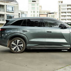 Side view of a sleek grey metallic electric SUV featuring aerodynamic alloy wheels.