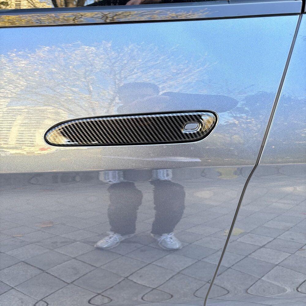 Carbon fiber texture door handle cover for car in a sleek grey finish.