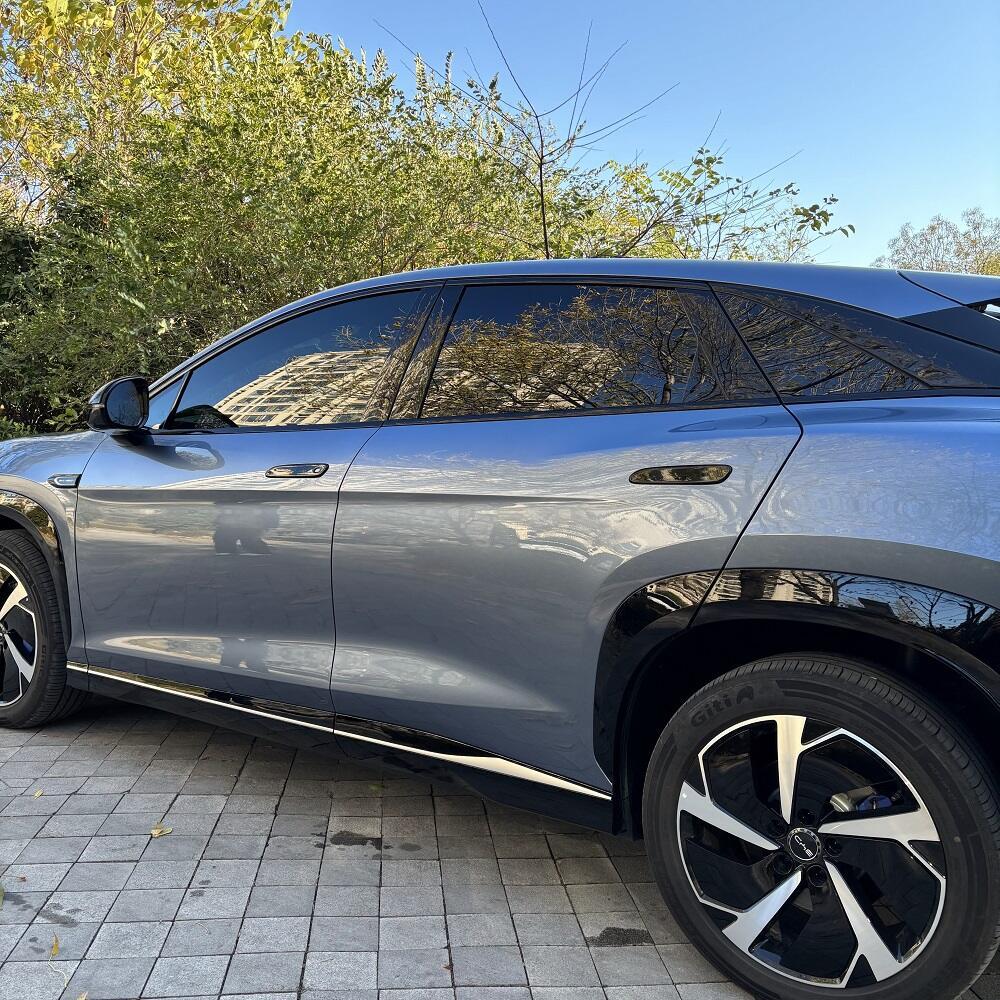 Side view of a sleek grey BYD electric car with tinted windows and black alloy wheels.