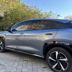 Side view of a sleek grey BYD electric car with tinted windows and black alloy wheels.