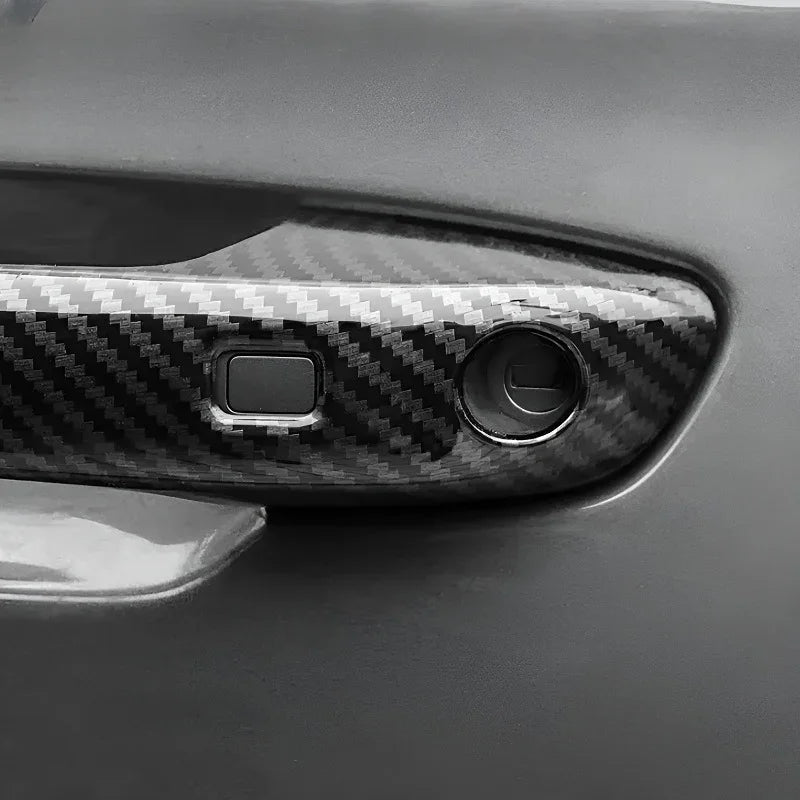 Glossy black carbon fiber patterned car door handle cover for enhanced protection and style.