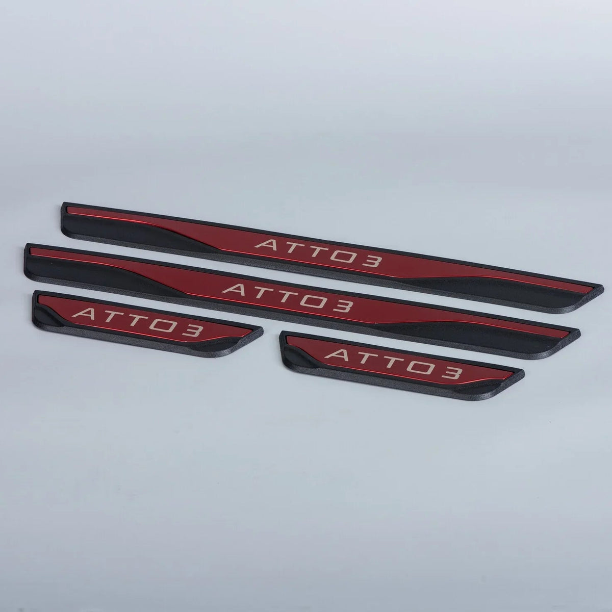 Red and black metallic ATTO 3 door sill protector plates with engraved lettering.