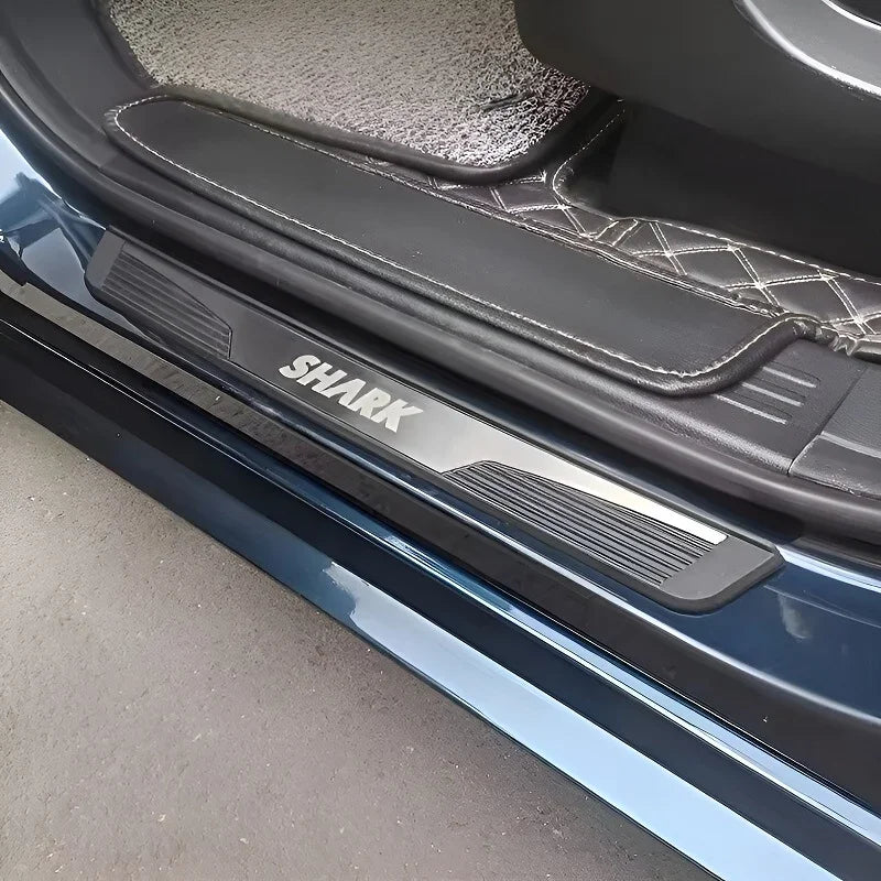Shark branded black protective door sill plate installed on a vehicle's threshold.