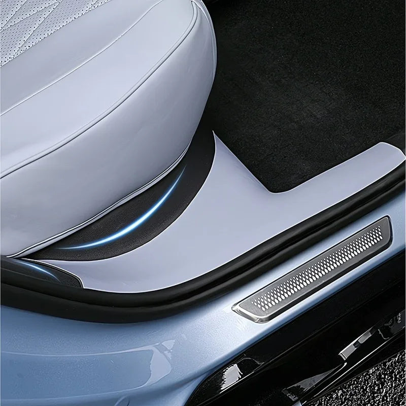 Light blue custom-fit car door sill protector with textured silver metal inlay.