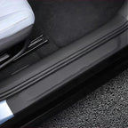 Black leather-textured car door sill protector for enhanced interior protection.