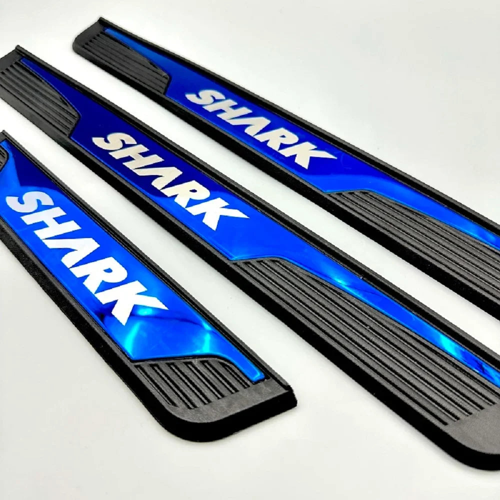 Three blue and black durable plastic SHARK branded car door sill protectors