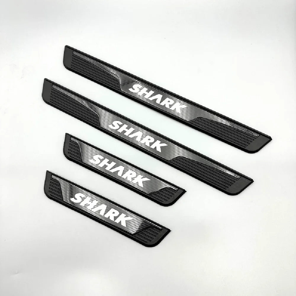 Set of four black textured car door sill protectors featuring white SHARK branding.