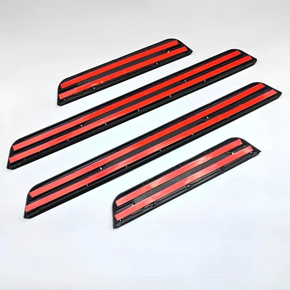 Set of black durable plastic car door sill protectors with vibrant red accent stripes.