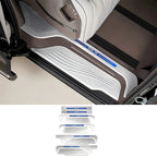 Silver metallic door sill protector plates with blue accent trim for BYD vehicle interior.