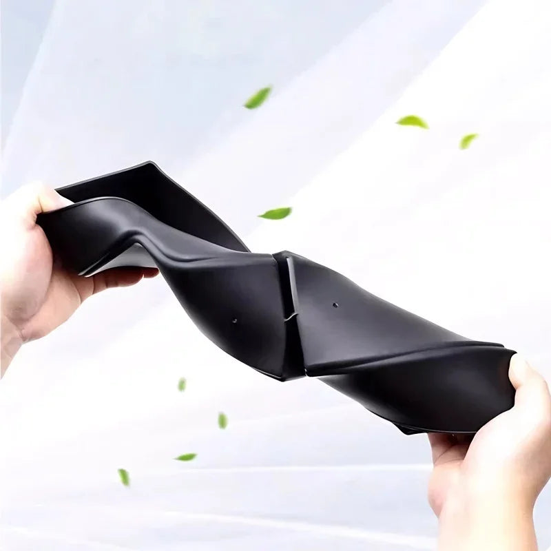 Flexible black leather-textured car floor mat being bent to demonstrate durability.
