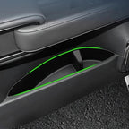 Black leather car door pocket featuring vibrant green LED ambient lighting.