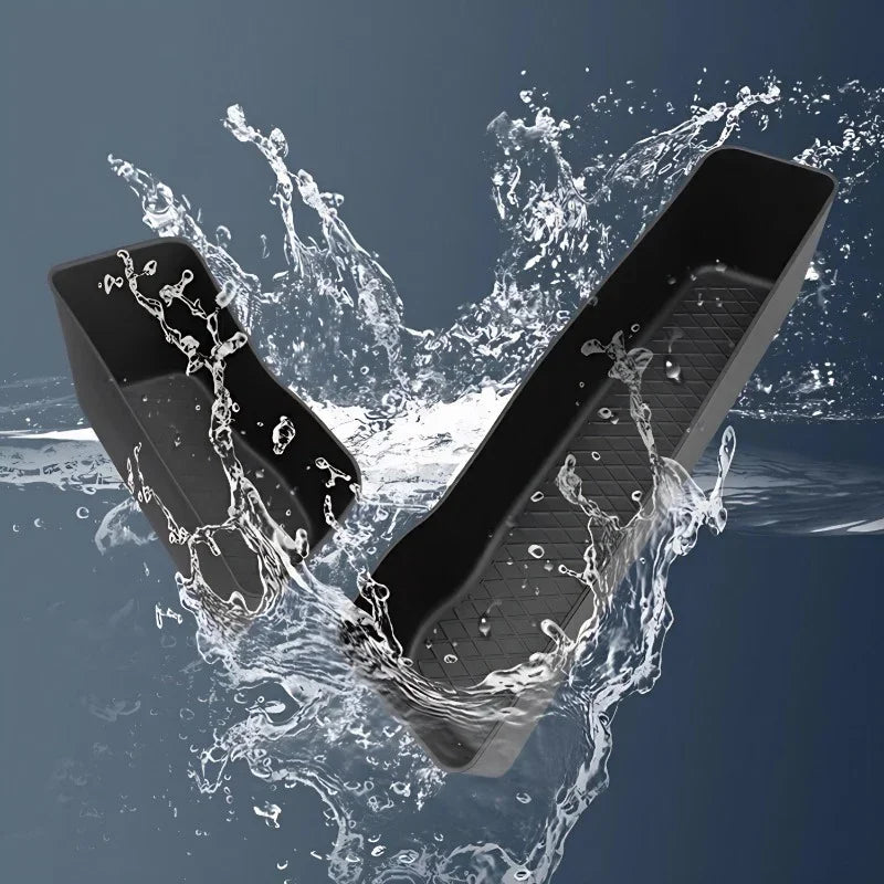 Waterproof black textured TPE car floor mats splashing in water for maximum protection.