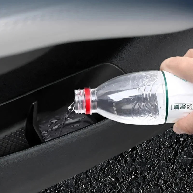 Water being poured into a black waterproof car door pocket protector.