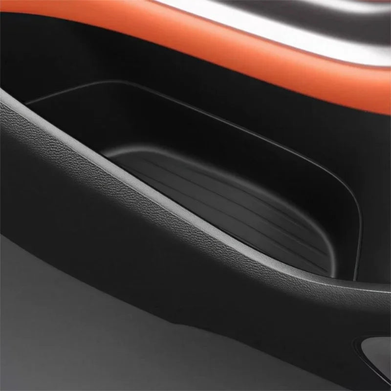 Black textured TPE car center console tray for organized storage and spill protection.