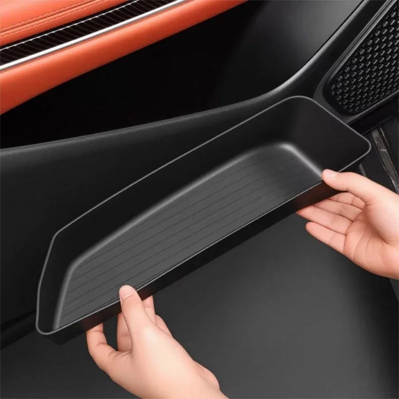 Black matte ABS plastic door pocket organizer tray for BYD vehicle interior storage.