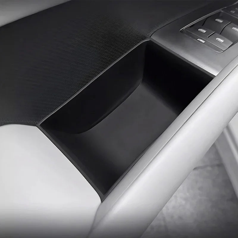 Close-up of a black textured car door storage bin with a sleek, professional finish.