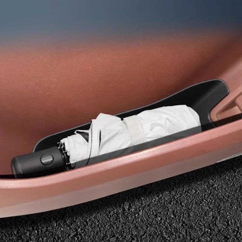 Black durable plastic umbrella holder installed in a brown car door side pocket.