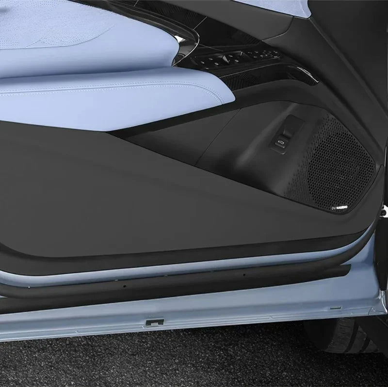 Black protective door sill plate and interior trim for BYD vehicle with light blue leather seats.