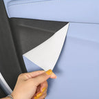 Peeling back light blue faux leather protective film to reveal durable black interior surface.