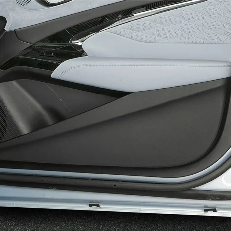 Premium light grey leather-textured door panel trim with sleek black protective cover.