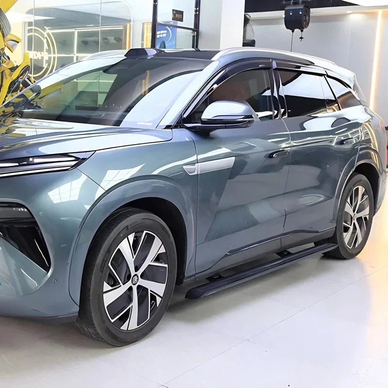 Grey BYD SUV featuring sleek silver alloy wheels and protective black side steps.
