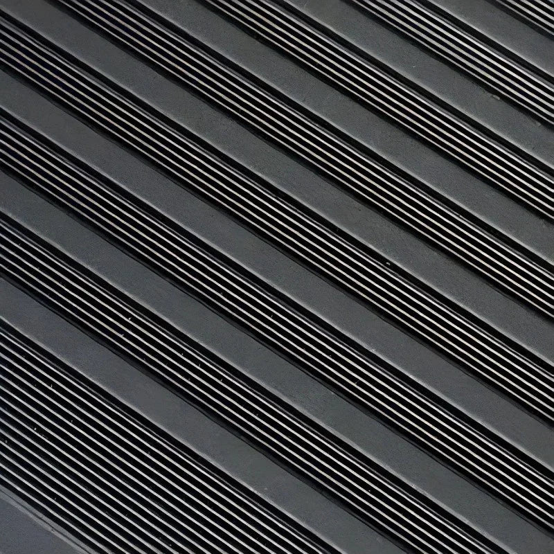 Black textured rubber car floor mat with durable anti-slip ribbed pattern.