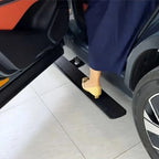 A person wearing yellow heels stepping onto a black textured side step running board of a car.