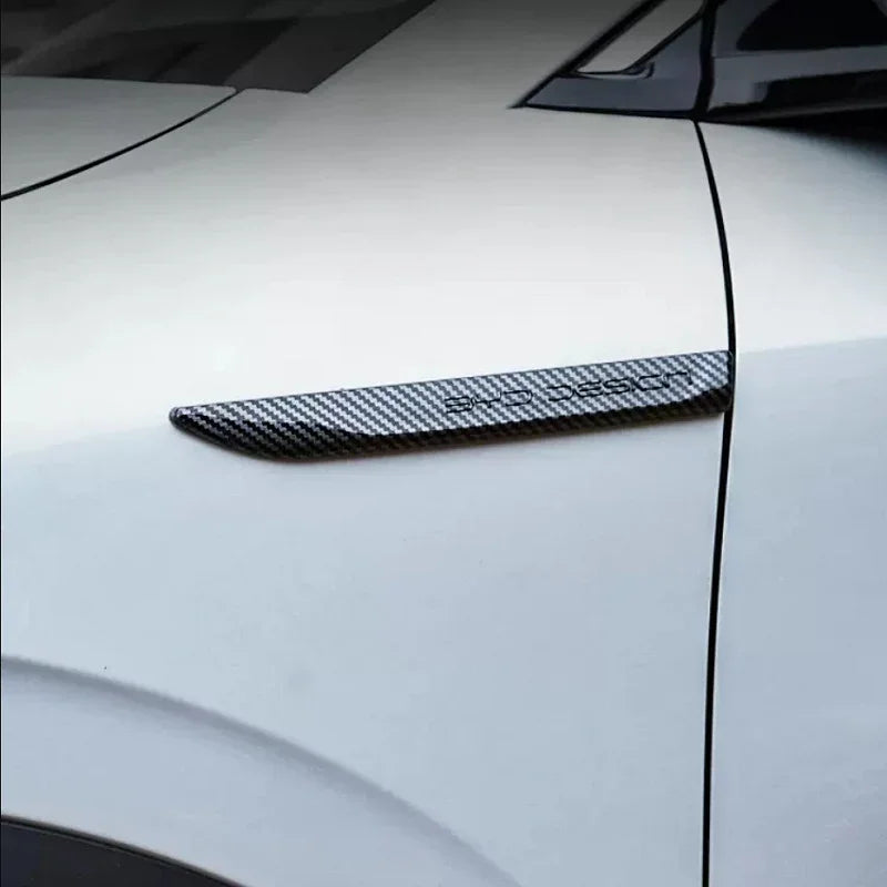 Carbon fiber texture door trim accessory for BYD vehicles in black and grey.