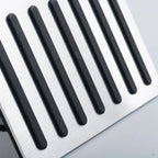 Close-up of a brushed silver metal pedal pad with non-slip black rubber strips.