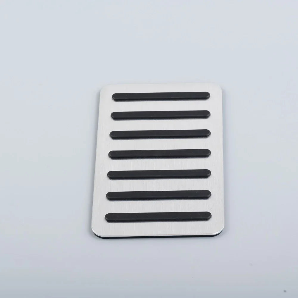 Silver brushed aluminum car pedal cover with black anti-slip rubber grips.