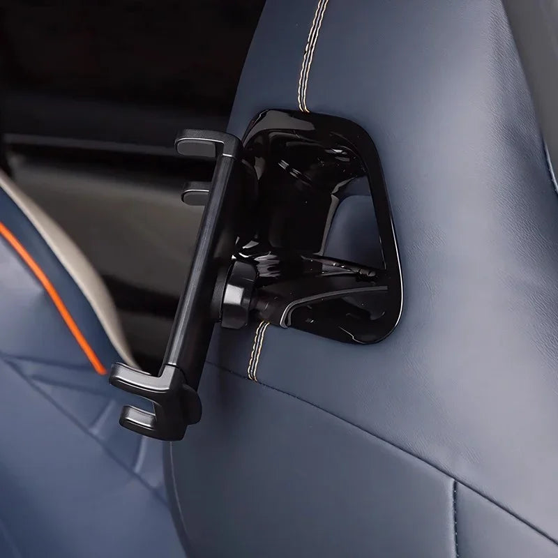Glossy black heavy-duty seat back hook mounted on blue leather car upholstery.
