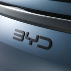 Matte black 3D BYD emblem mounted on a sleek metallic blue car body.
